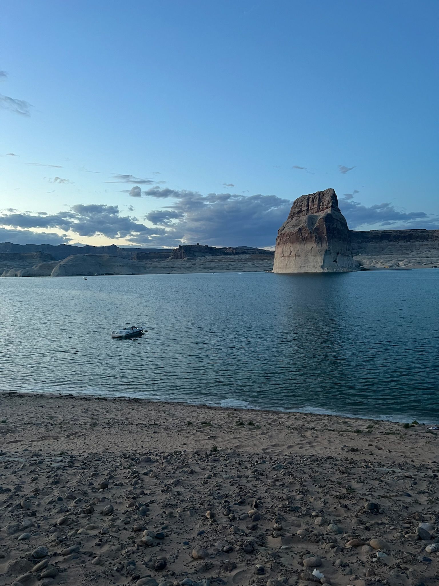 Vista of a vast expanse with large boulder in lake
